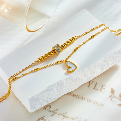 Gold double layer anklet with heart charm and beaded details, fashion jewelry accessory for women