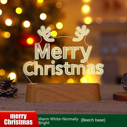 3D acrylic LED Christmas decoration lamp with "Merry Christmas" text and reindeer antlers on wooden base in warm white light