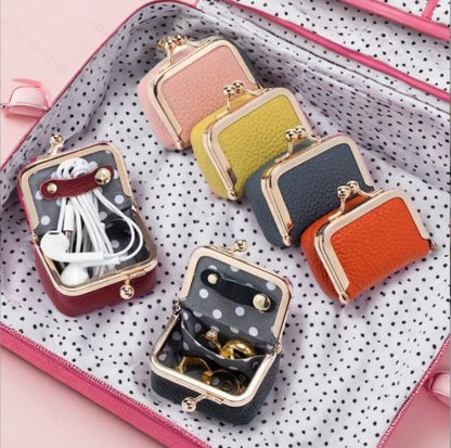 Colorful genuine leather mini jewelry cases with gold clasps, compact and portable for travel storage.
