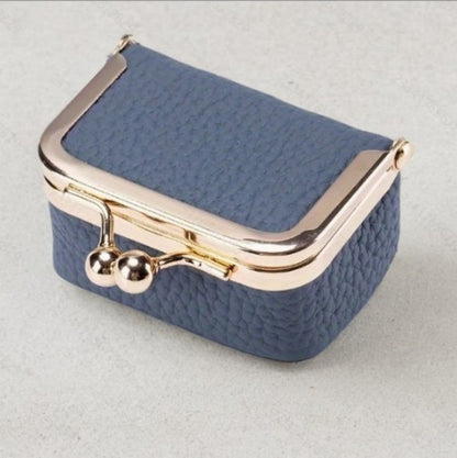 Compact genuine leather mini jewelry case in blue with gold clasp, ideal for storing rings, earrings, and small necklaces.