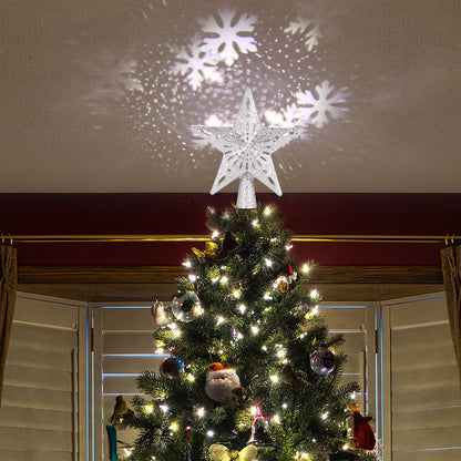 Silver star-shaped Christmas tree top light projecting snowflake patterns on ceiling